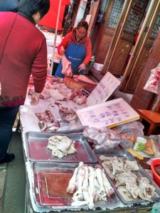 Woman butchering pig.