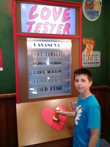 Damian trying the Love Tester at Moe's.